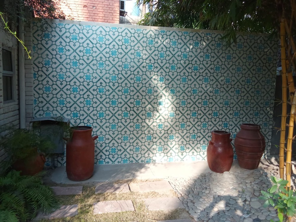 Garden feature wall in teal patterned tile