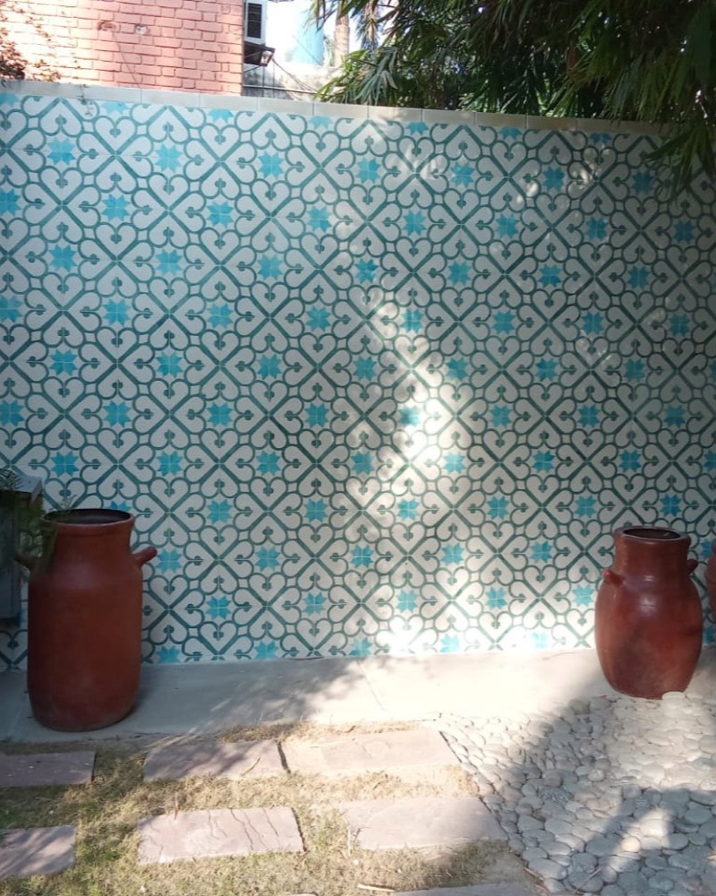 Patterned tile feature wall with terracotta vessels